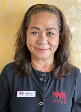 A woman with a headband, smiling at the camera.
