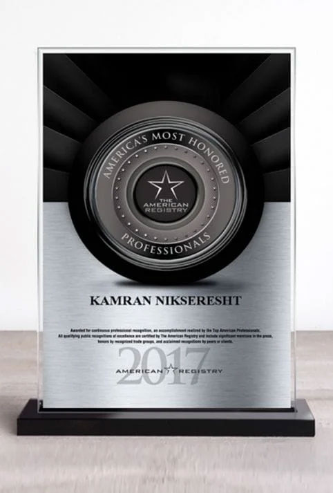 A shiny plaque with a medal design, featuring a central emblem and text, against a dark background.