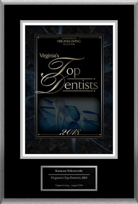 An award plaque for the Virginia Top Dentists 2018, featuring a photo of a dental professional and text recognizing their achievement.