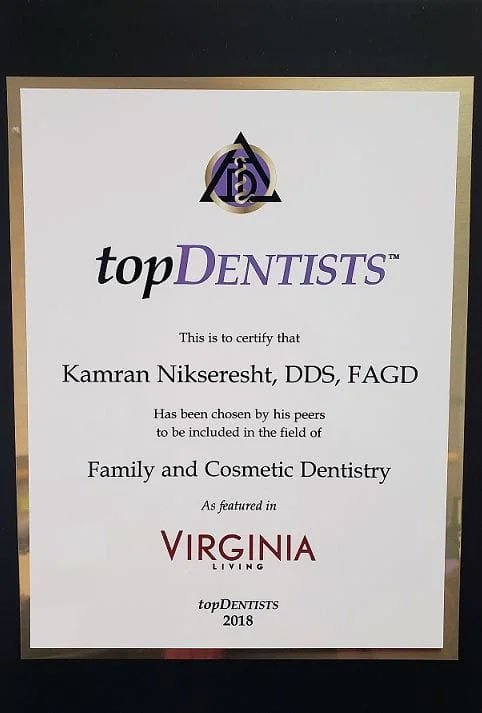 The image shows a plaque with text and logos, recognizing an achievement in dentistry.